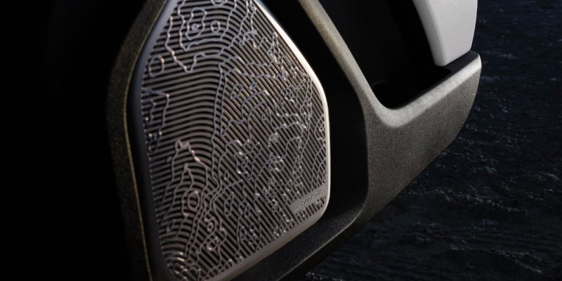 
Close-up of a Bose speaker grille with a topographical map pattern design inside a vehicle.